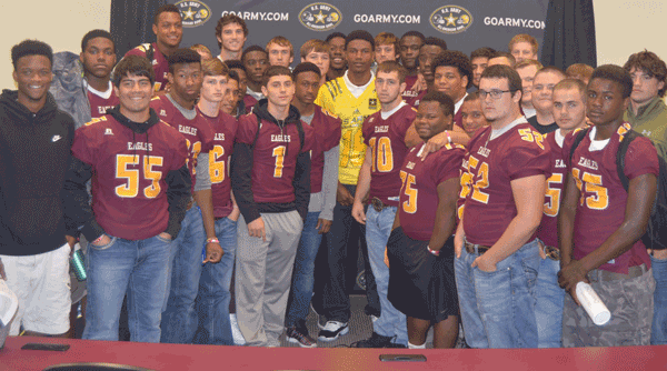 Charles Oliver surrounded by his teammates