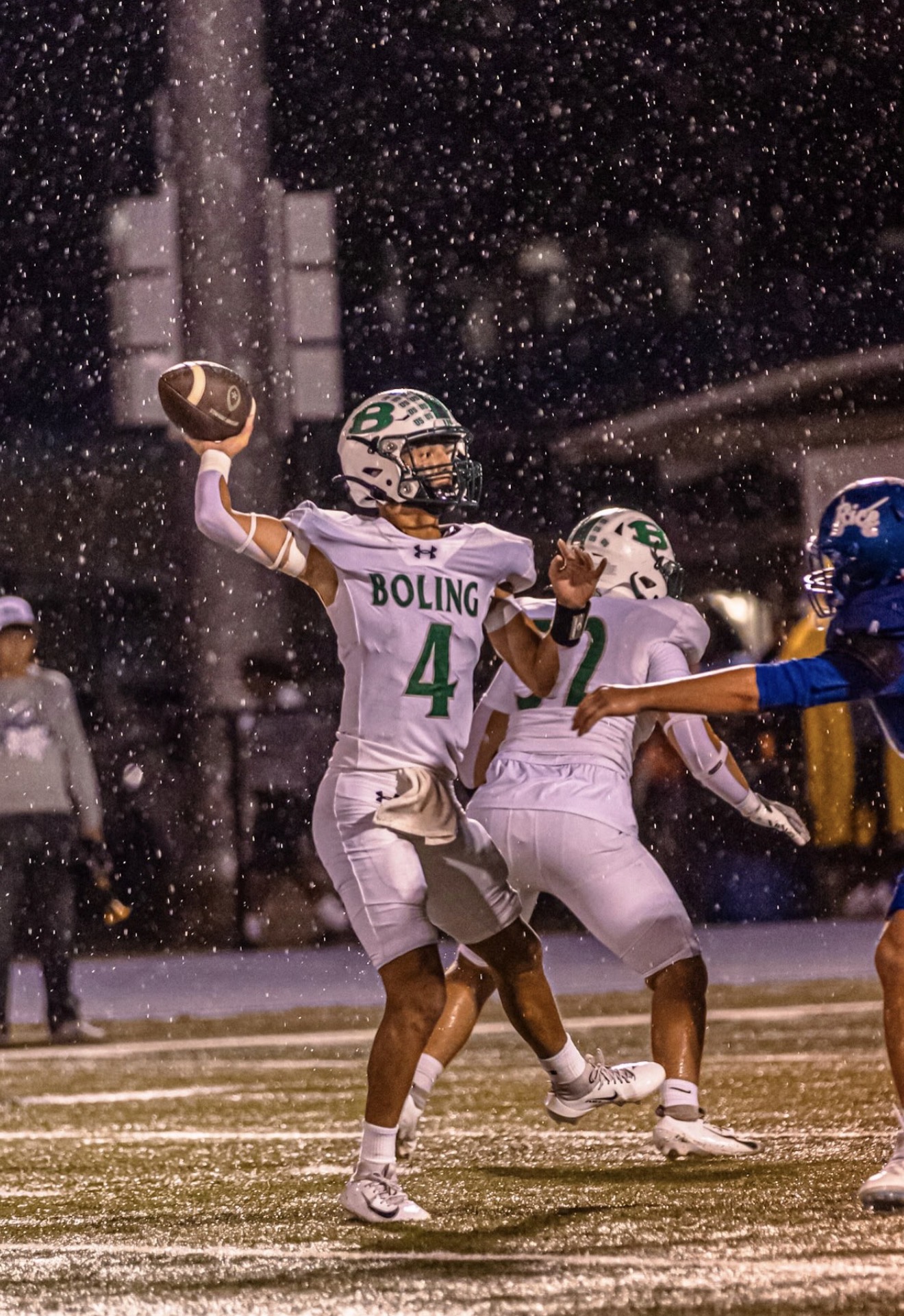 Boling quarterback Jace Urbanek prepares to pass in the rain against Rice Consolidated.